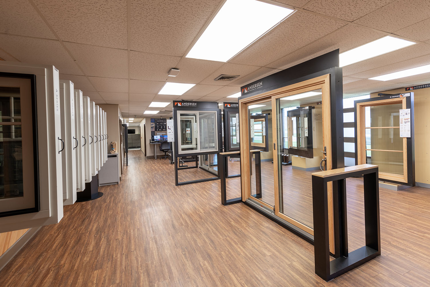 Interior view of a showroom with windows with hardwood flooring.